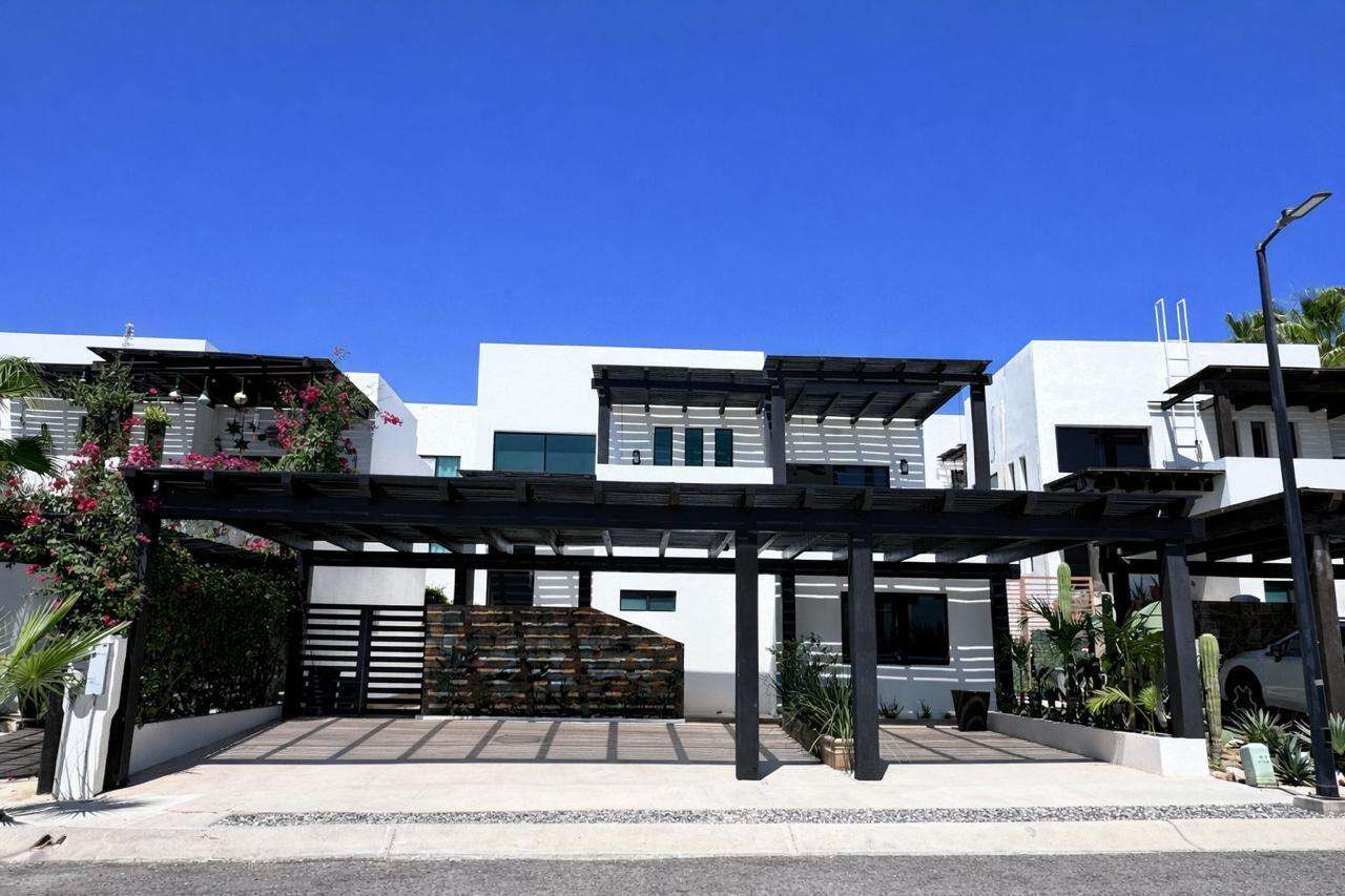Los Cabos Casa Mex-Agaves Situated within the Casa Mexicana - Agaves community, this thoughtfully designed three-bedroom residence offers a functional and well-planned layout. The main level features a bedroom with an en-suite bathroom and walk-in closet, ideal for guests, multigenerational living, or those seeking stair-free access.A spacious outdoor terrace on the first floor, surrounded by tropical landscaping, provides a serene setting for both relaxation and entertaining. With multiple seating areas, it stands out as a unique feature within Casa Mexicana. The upper level includes two additional bedrooms, each with en-suite bathrooms and walk-in closets, along with the home's main living and kitchen areas. The indoor spaces are seamlessly connected to an additional terrace, enhancing the home's indoor-outdoor living appeal.Additional features include a dedicated laundry area, a two-car garage, and accordion-style hurricane shutters, combining comfort with practicality and peace of mind. for sale
