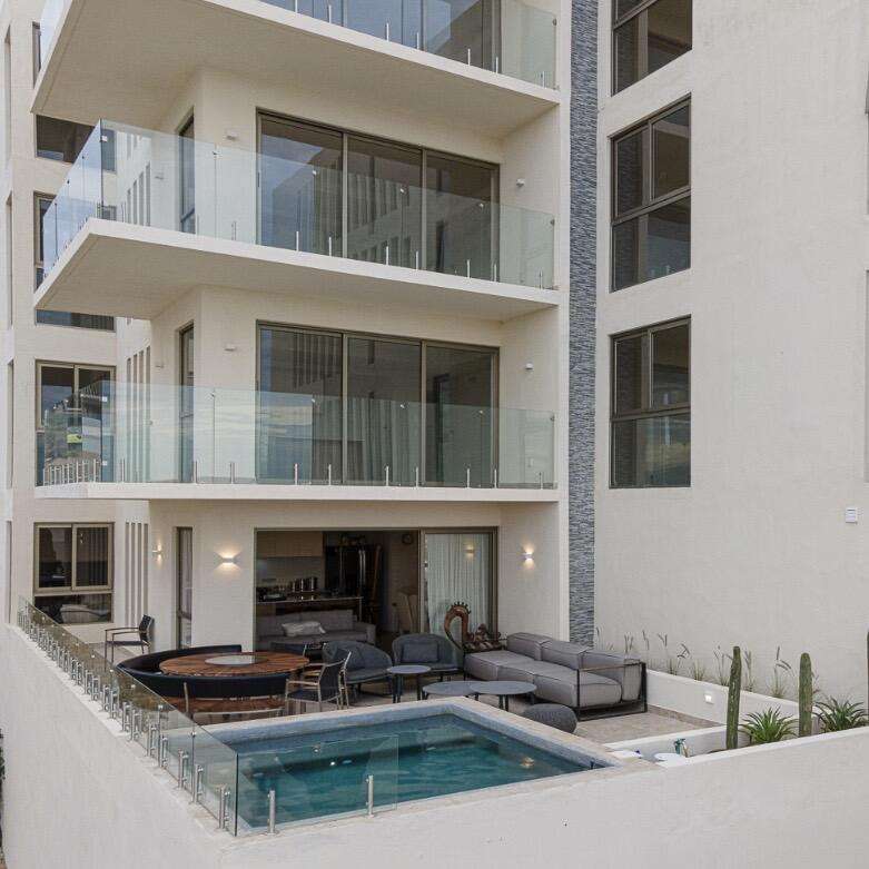 Los Cabos Marea Los Cabos Located in the exclusive Marea development, this 1,480 sq. ft. condo offers the premier downtown Cabo San Lucas lifestyle just 500 meters from Medano Beach. The contemporary, open-concept design features three spacious bedrooms--each with its own private balcony--and floor-to-ceiling windows that flood the sleek, white-cabinetry kitchen and living areas with natural light. This turnkey property is a lucrative opportunity for investors, coming fully furnished, equipped, and ready for immediate rental income with no renovations required. Residents enjoy premium community amenities, including 24/7 security, a lobby, a gym, and a sparkling pool. The standout rooftop terrace, with a jacuzzi , provides the perfect vantage point to take in the city for sale